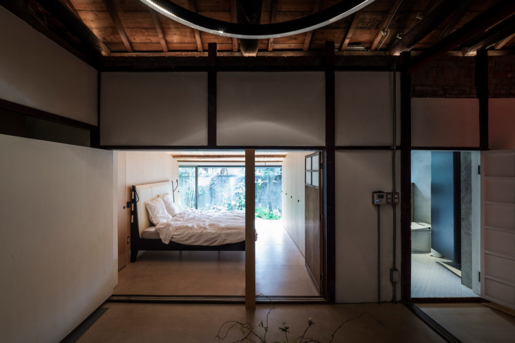 Living Lab bedroom with glass walls and view to outdoors