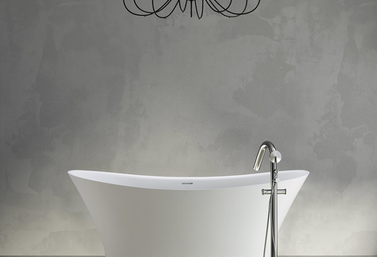 MTI Baths' Mallory Tub front view with floor-mounted fitting and chandelier above