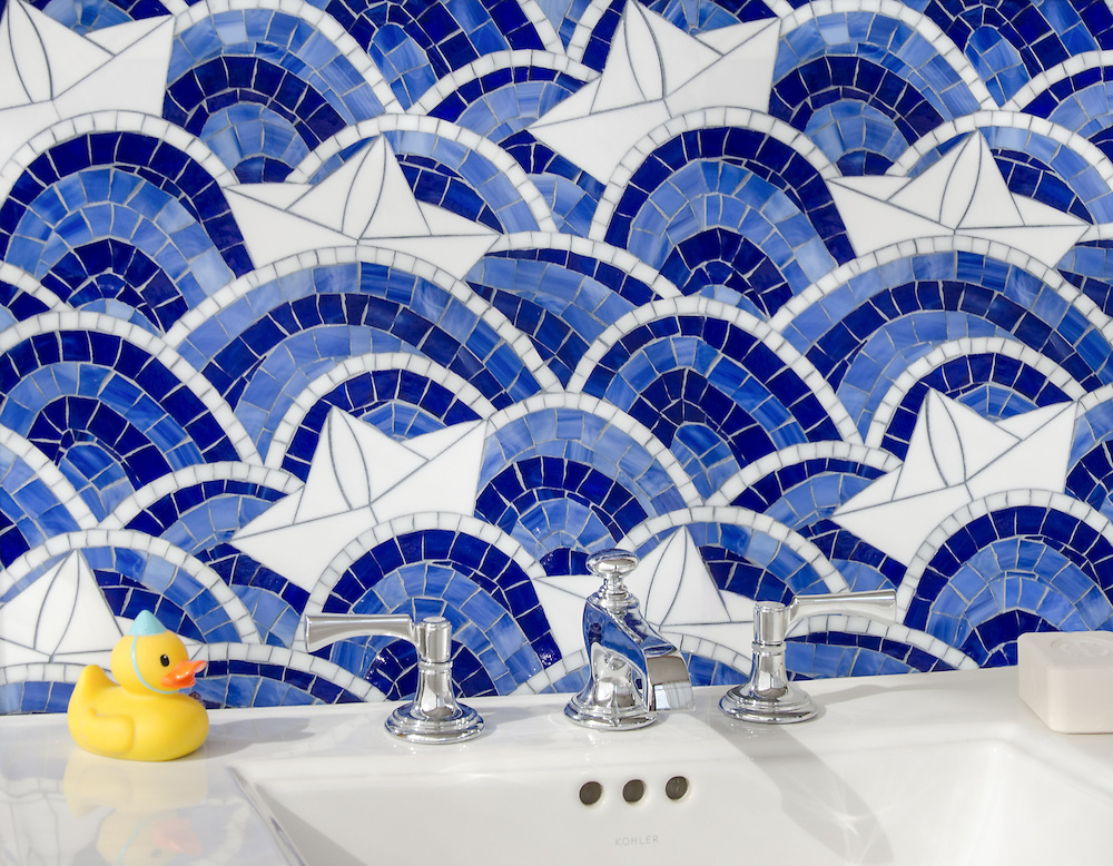 Blue Sea Glass Collection Fleet Style of boats amid blue waves with rubber ducky in foreground on top of bathtub