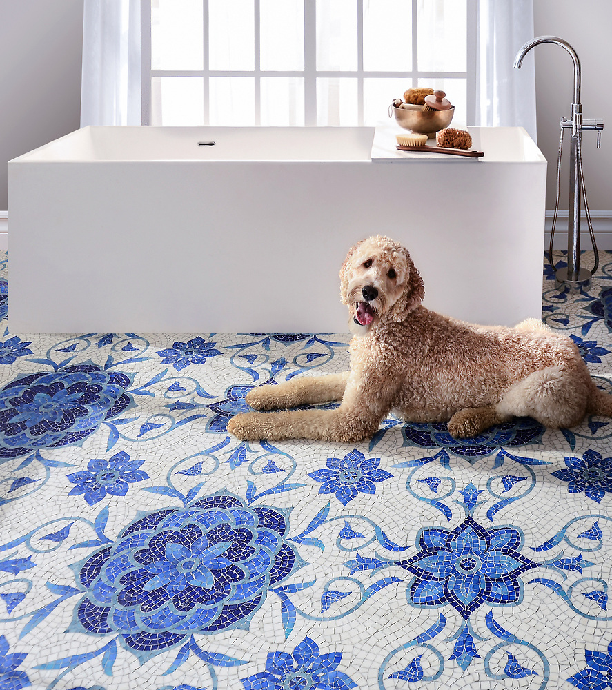 Blue Sea Glass Collection Aurelia style with floral shapes in light and dark blue against white background on floor of bathroom with Labradoodle dog