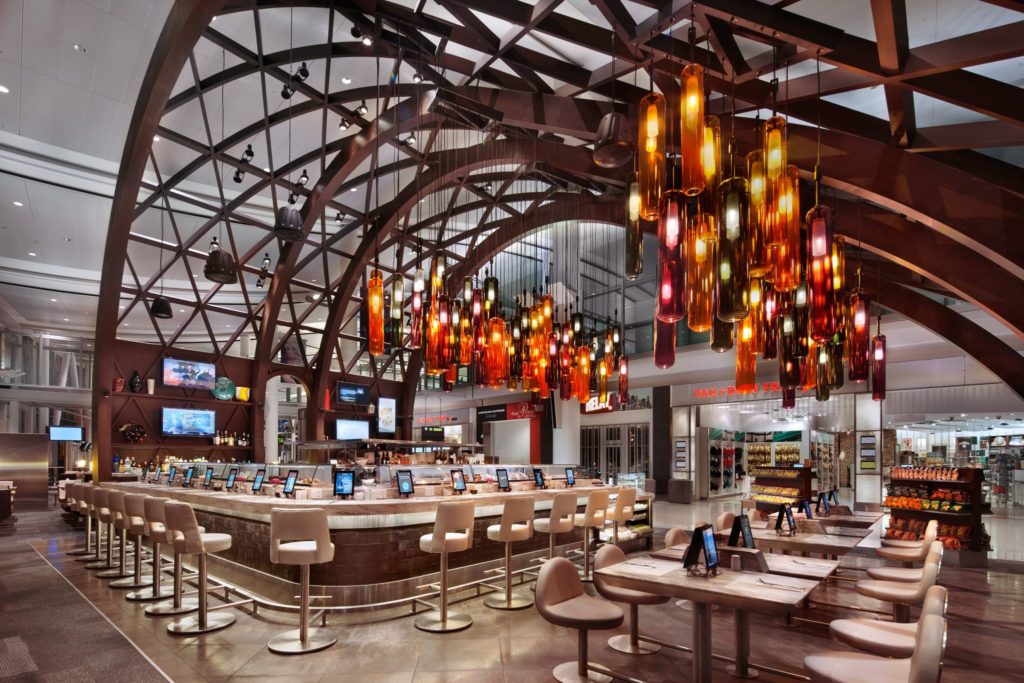 BDL Hospitality Lighting red, yellow, and orange glass pendants at Toronto's Pearson airport