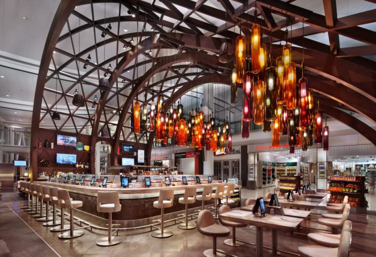 BDL Hospitality Lighting red, yellow, and orange glass pendants at Toronto's Pearson airport