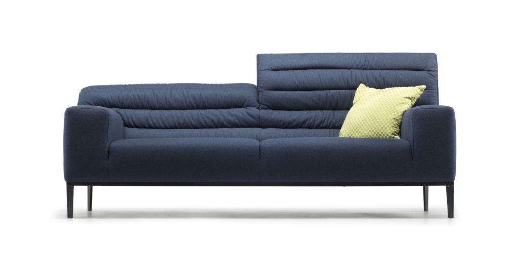 Claudio Bellini Shift Sofa in dark blue with elevated headrest on one section and greenish pillow front view