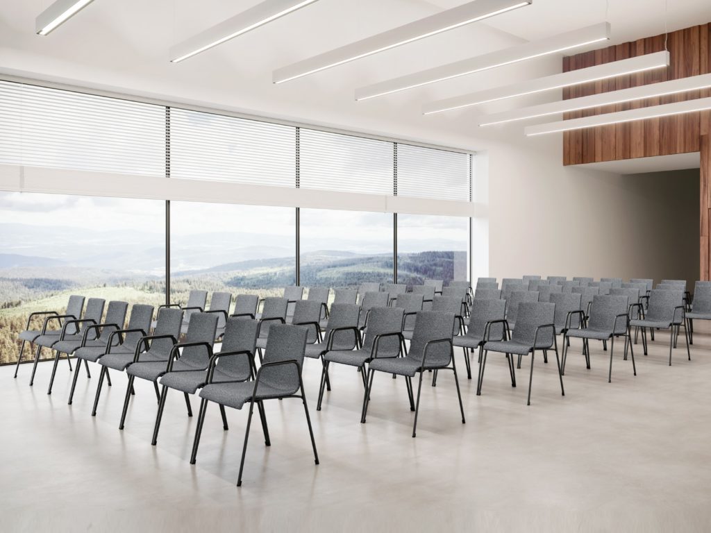 Claudio Bellini Liz-M chair many gray chairs in open auditorium with a view of spacious countryside through window