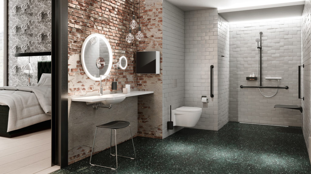 Hewi System 900 Support rails in black shown in spacious bathroom with green floor and brick wall