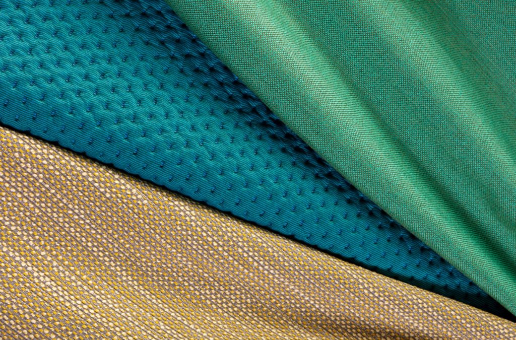 Unika Vaev's Bond Street Collection Agile in sand color shown with two other fabrics in green and aqua blue