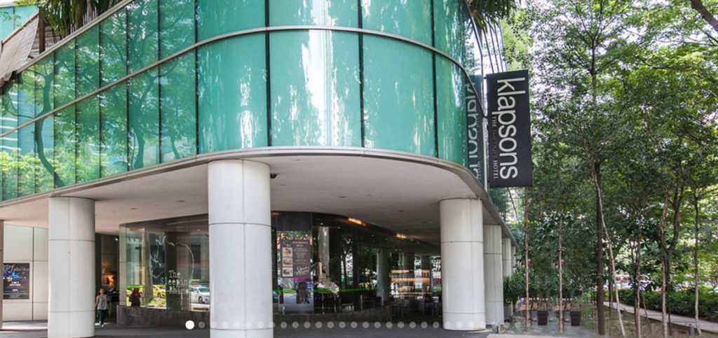 William Sawaya exterior Klapsons Hotel in Singapore with big white pillars and blue glass