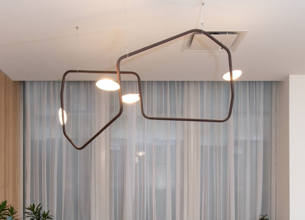 Rich Brilliant Willing Palindrome chandelier with translucent curtains in background