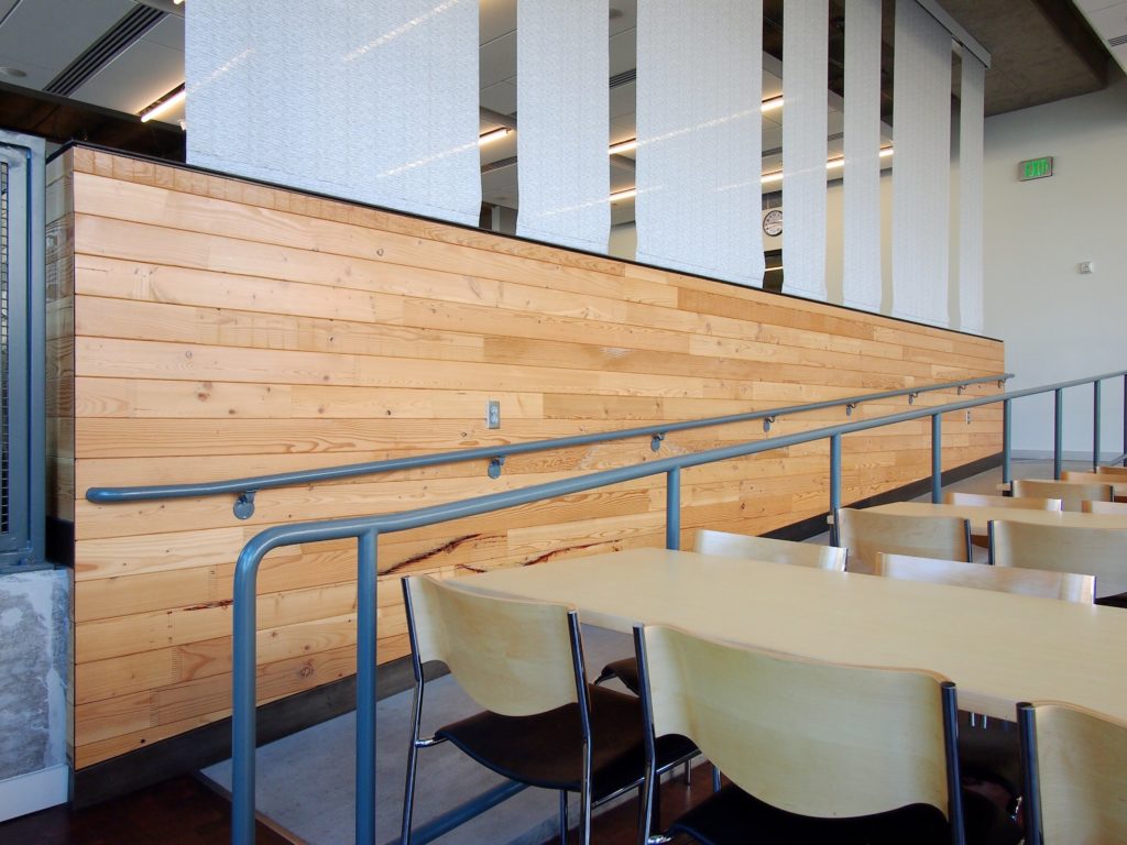 Windfall Lumber Portland cladding light natural wood on half wall in high school cafeteria