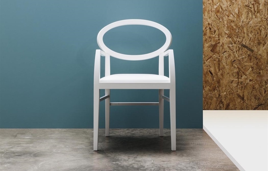William Sawaya Zarina Chair in white in front of blue wall on gray stone floor