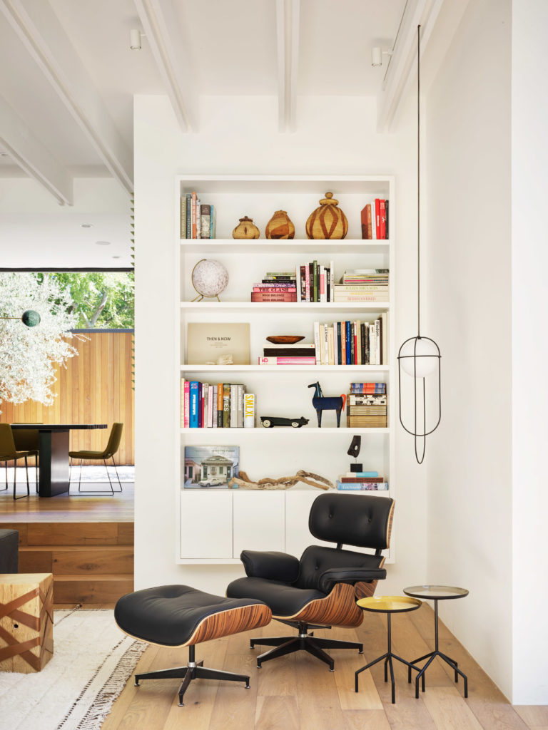 Assembledge+ Laurel Hills view of interior living area with Eames Lounge and built-in bookcase