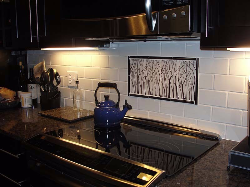 BonTon tile custom installation on kitchen wall behind cooktop with barren winter trees on white background