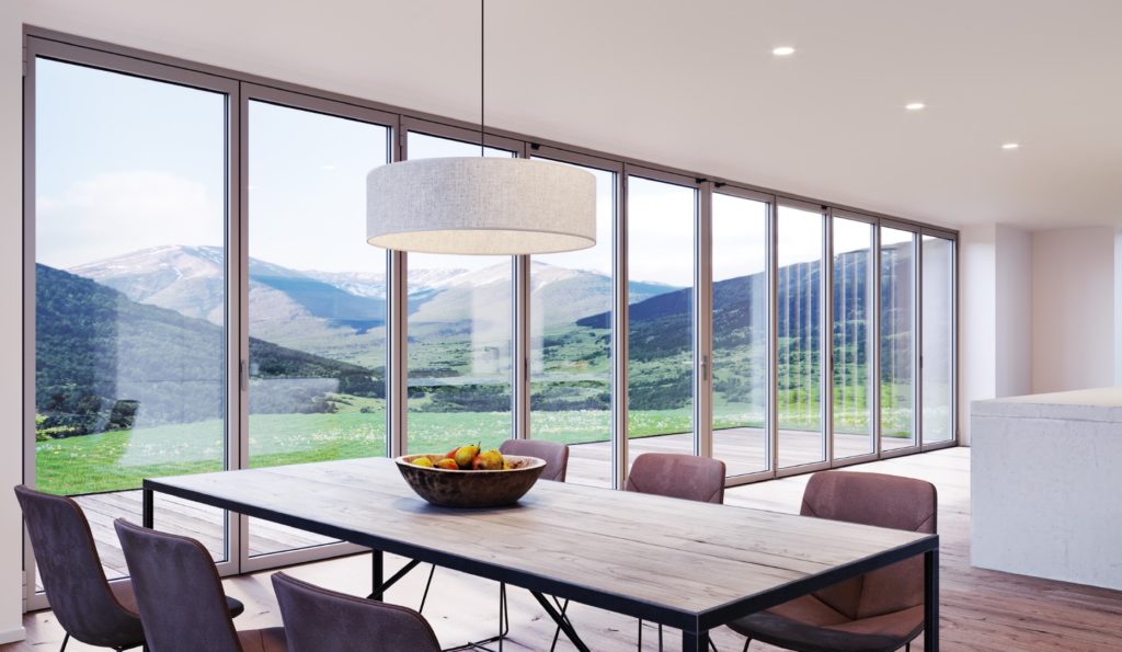 NanaWall's SL84 folding glass wall  10 panels in closed position looking from kitchen onto mountains