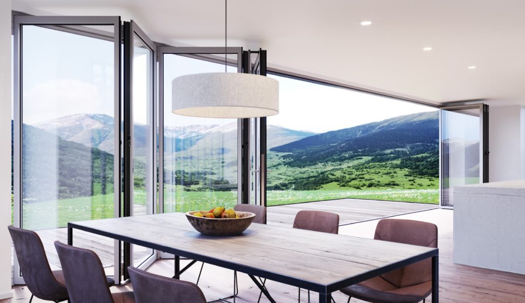 NanaWall's SL84 folding glass wall four panels partially open looking from kitchen out onto mountain view