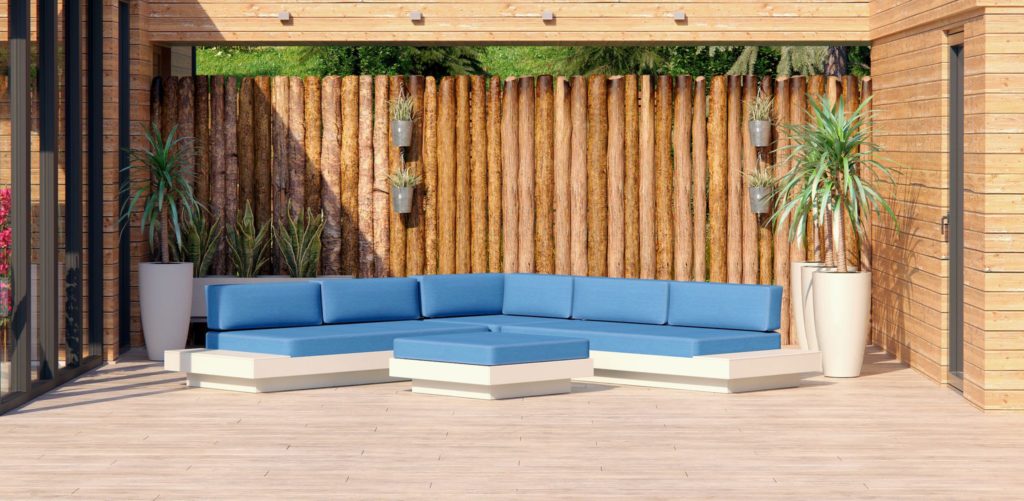 Loll Designs outdoor seating Platform One with background of rough log fence