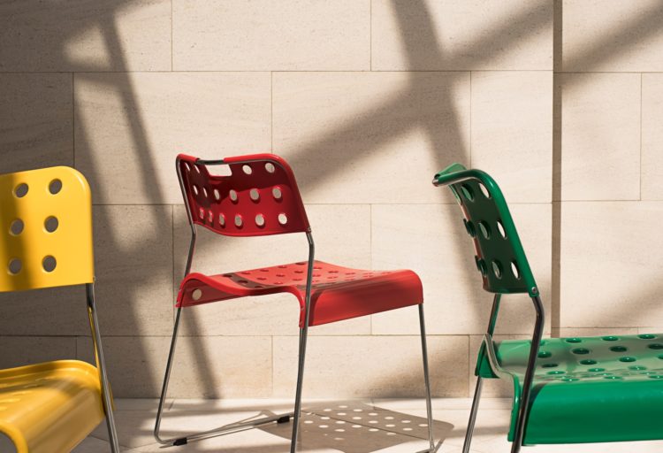 Sandler Stak Chair yellow, red, green on outdoor patio