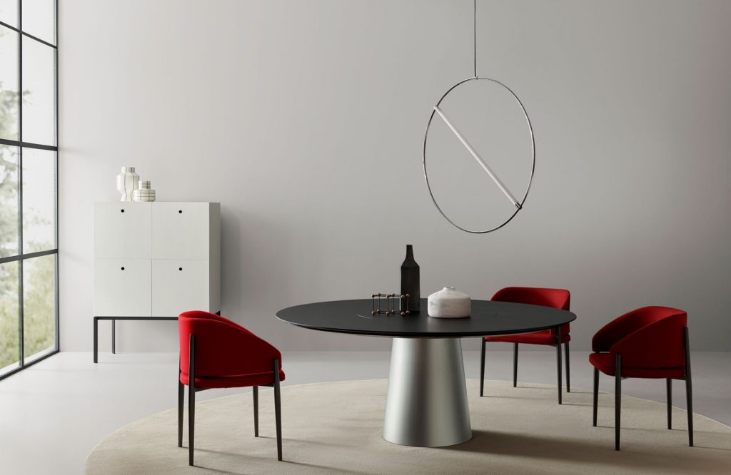 Porro's Materic Table with red chairs in spacious room