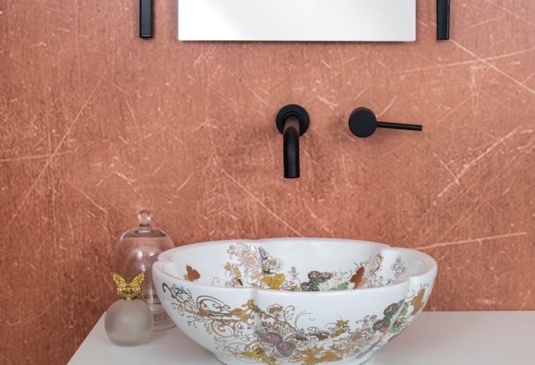 Zeina washbasin in white against peach wall on white vanity