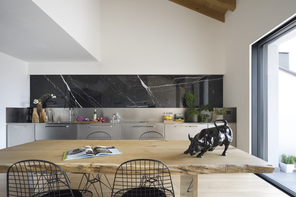 Atelier by Abimis wood table with cooktop in background

