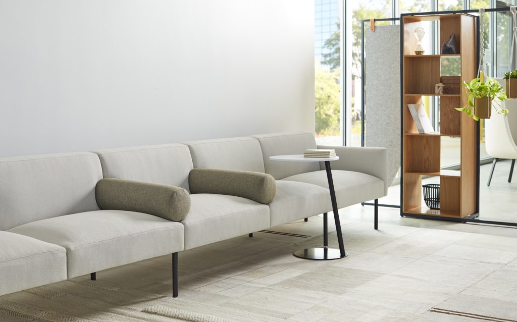 Jetty:Mod by Allsteel gray sofa with circular armrests and café table