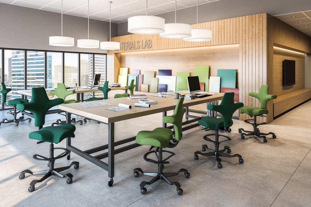 HÅG Capisco green and dark green around conference table in airy office