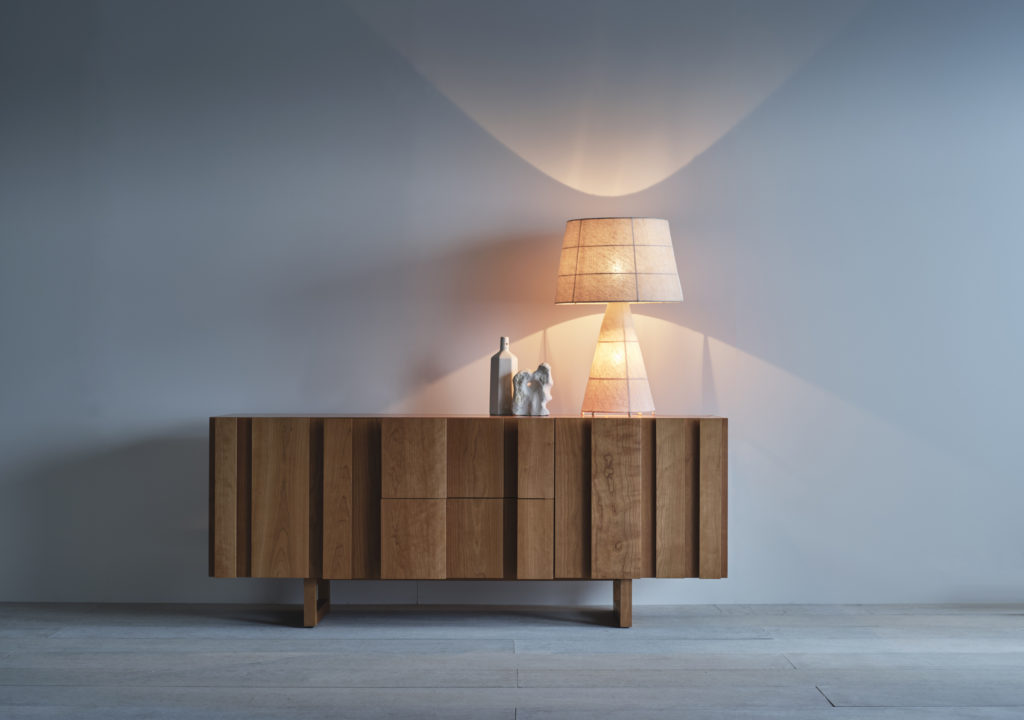 Pinch Lighting Gentle Table Lamp illuminated on credenza