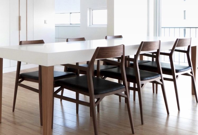 Aya chair in oak with black leather seat at kitchen