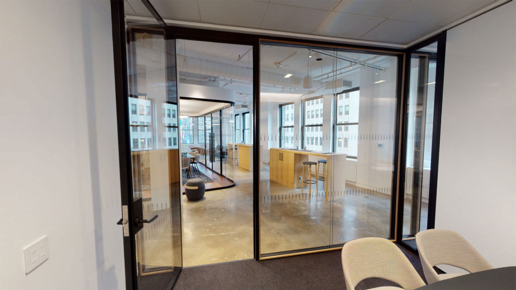 Muraflex Cuadro architectural glass partitions black anodized and walnut trim view from inside office