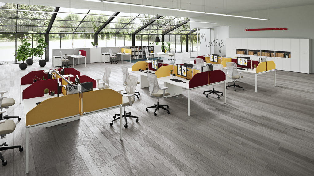 Vista Essence desks in white with red and yellow partitions in sunny office space 