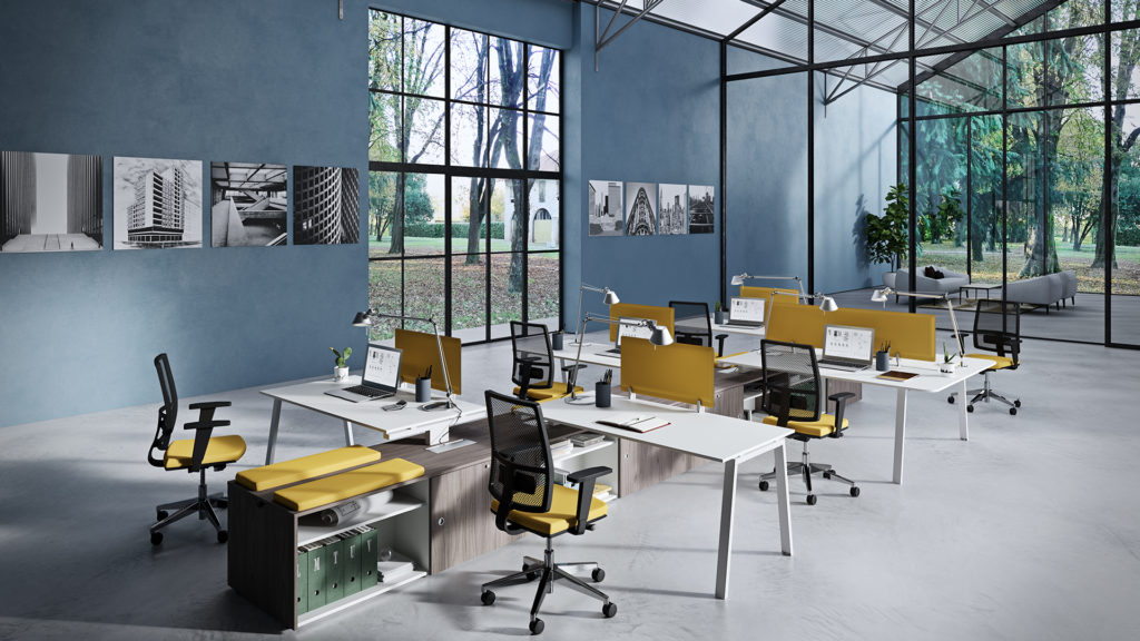 Vista Essence desks with white surface and black/yellow work chairs  in modern office space with view of trees 