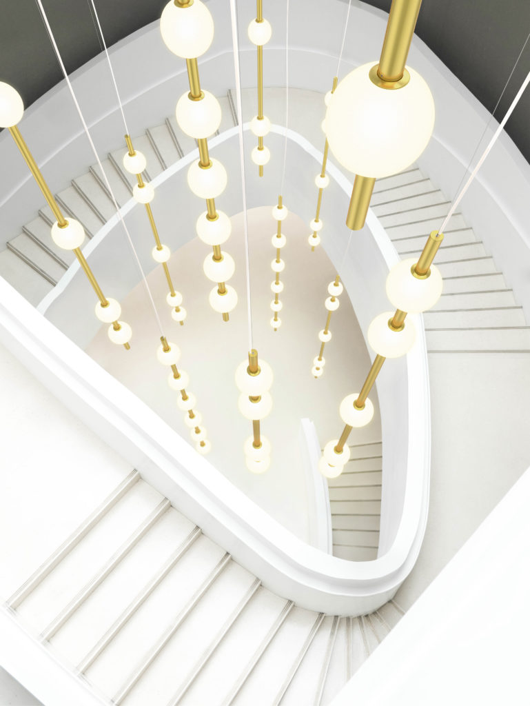 Berri Architectural Luminaire dramatic vertical installation many tubes and lights in staircase with gold tubes