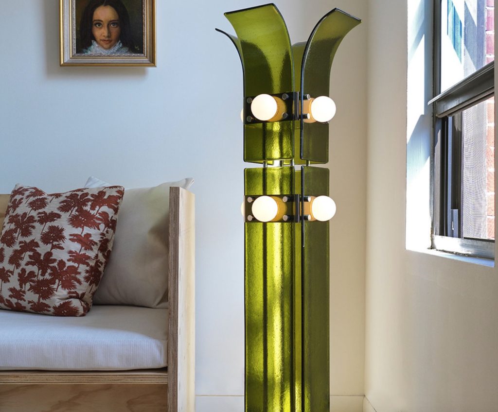 Palm floor lamp in green next to sofa