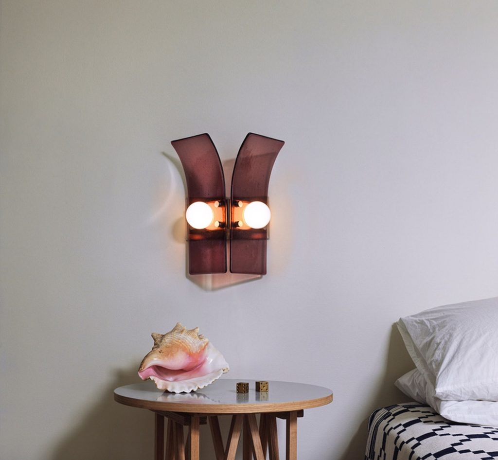 Palm bronze sconce above seashell in plum 