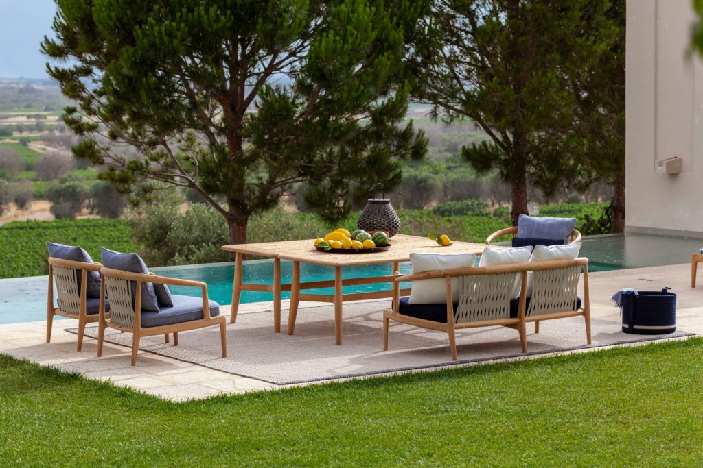 Boundless Living Secret Garden collection chairs, sofa, and table next to pool 