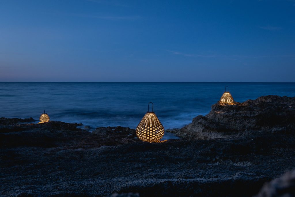 Boundless Living three Sparkler lamps illuminated on rocky beach 