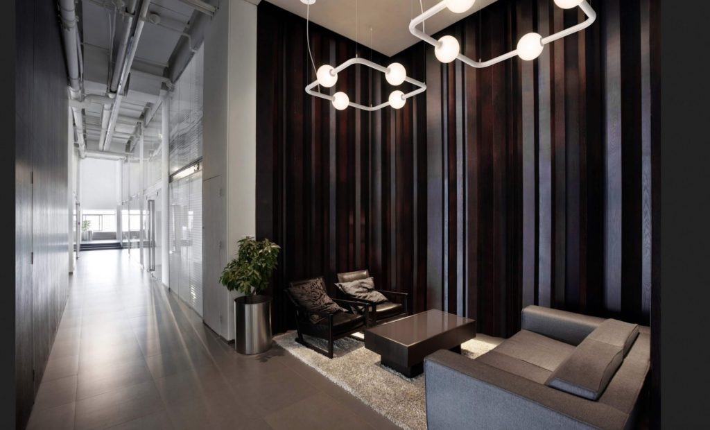 Berri Architectural Luminaire one square, one rectangular in hallway nook above seating