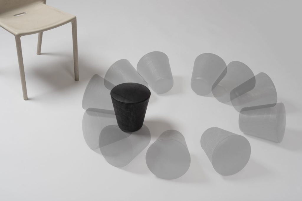 Movement Moulds material exhibit with wastepaper basket that falls and rolls back up next to chair