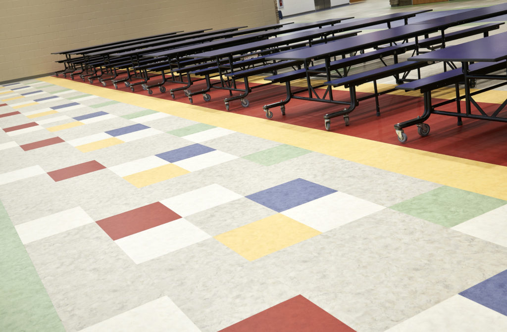 AVA SPRK LVT colorful squares and grays/whites in school cafeteria