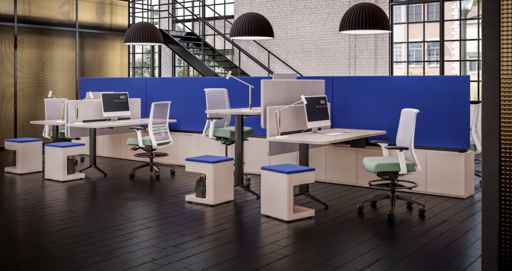 EverySpace workstations with white desks, black bases, green and white chairs and large blue privacy screens with open staircase in background