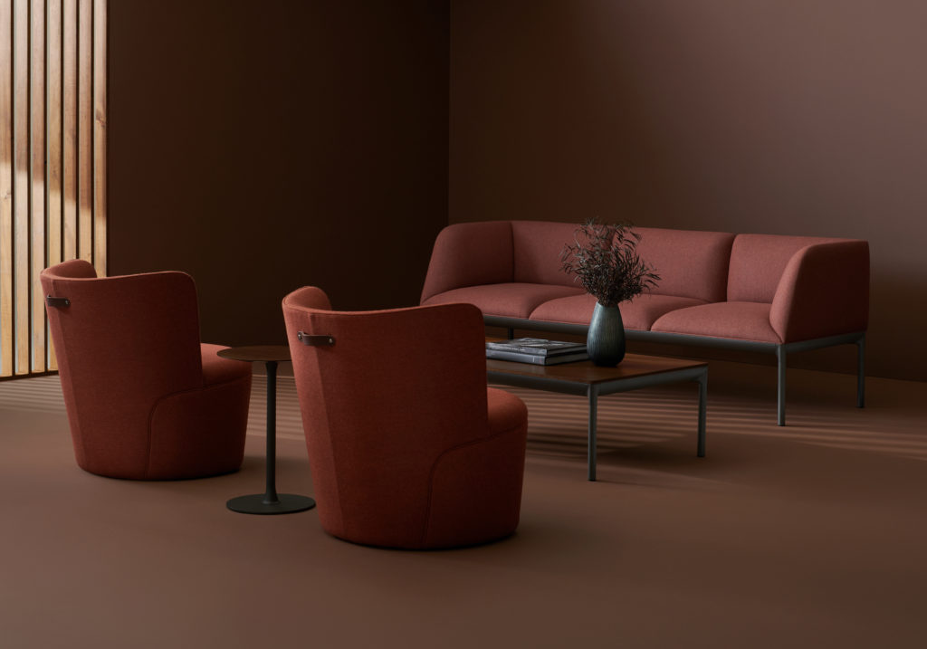 Davis Furniture's Tote two chairs in pink/red across from sofa in same color with coffee table in dark room