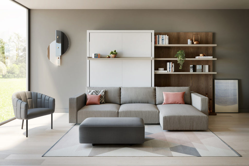 Swing as sofa with gray upholstery in neat room with ottoman, chair, and bookcase
