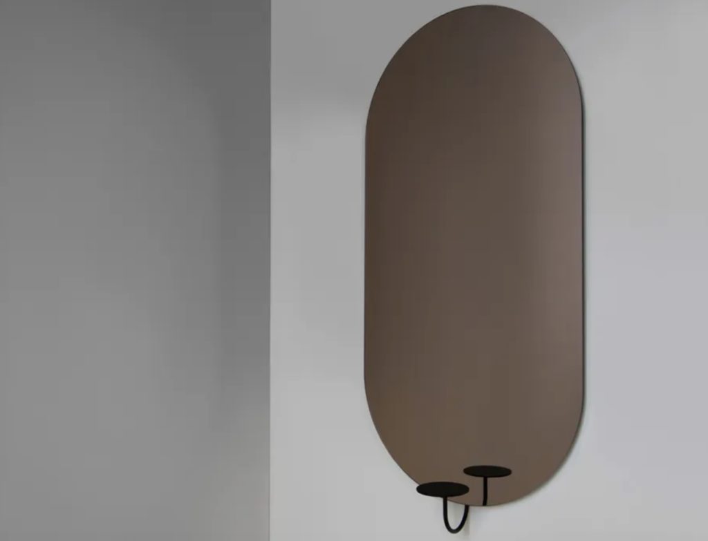 Friends & Founders Miró Miró mirror oval shaped with a small circular shelf attached at the bottom 