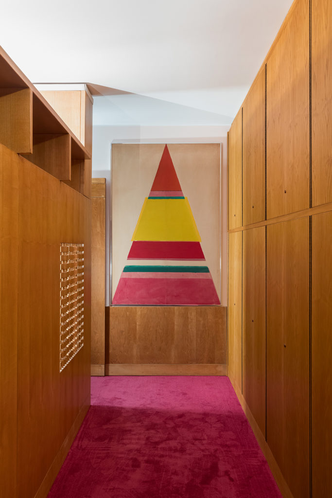 Casa Lana corridor with drawing of colored pyramid and wood screens