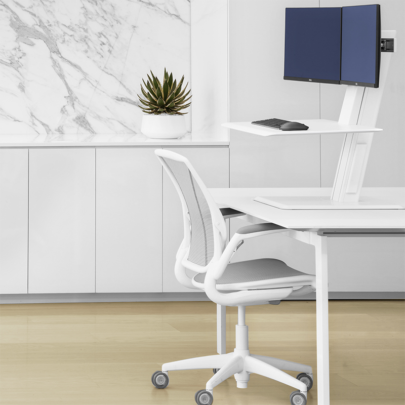 QuickStand Eco side view with monitor on white desk with white task chair