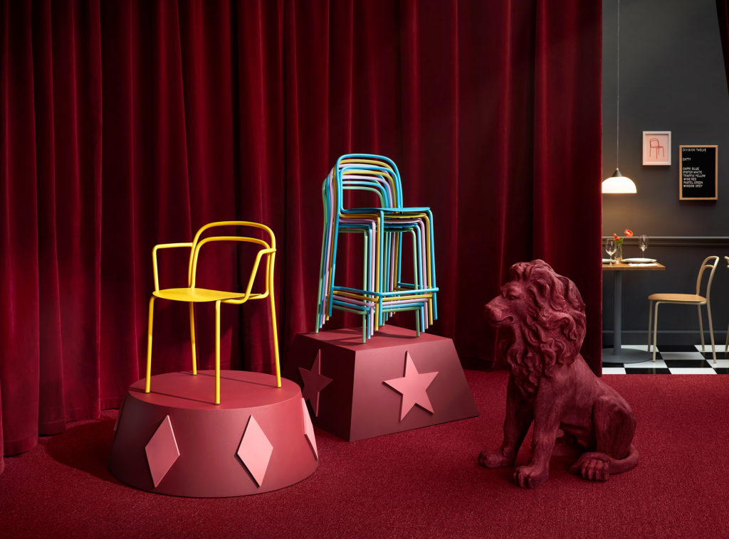 Division Twelve Catty Chair several chairs as if a lion tamer's set up with red curtains and statue of a lion