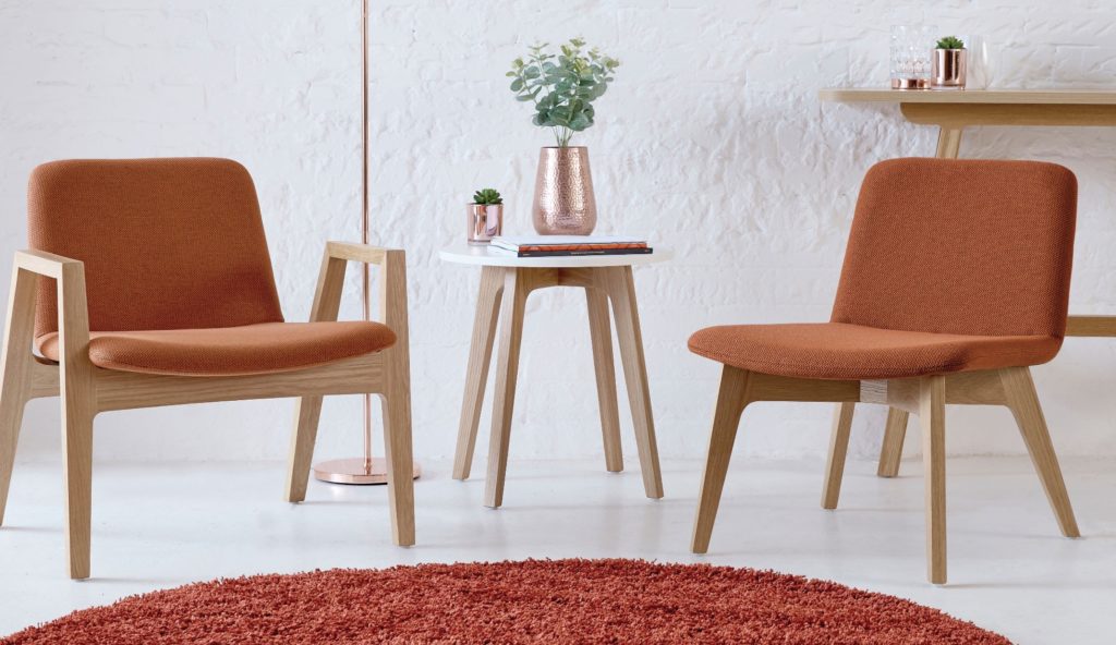 Agent Bistro table with lounge chairs in rust-colored upholstery