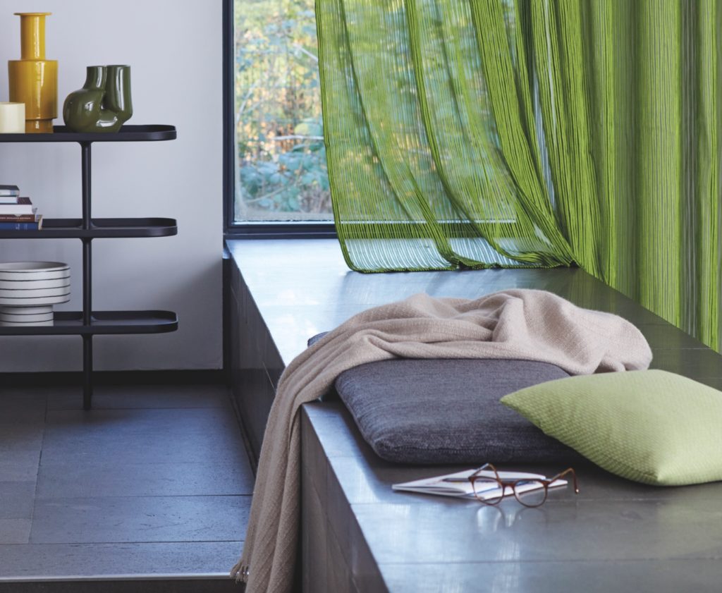 Green Relax fabric blowing in breeze on built-in bench