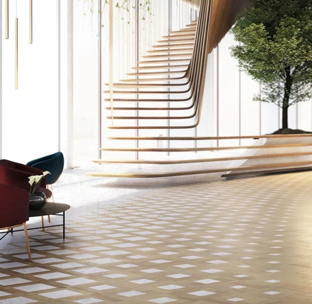 Cora parquet floor warm wood tones with white inlaid ceramic in open room with interesting wooden staircase