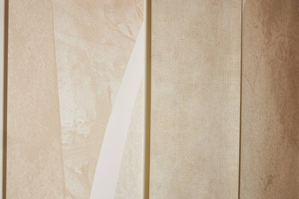 Close-up view of wallpaper with abstract pattern in muted whites and browns