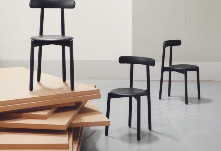 Bice three chairs in black with one atop wooden platform